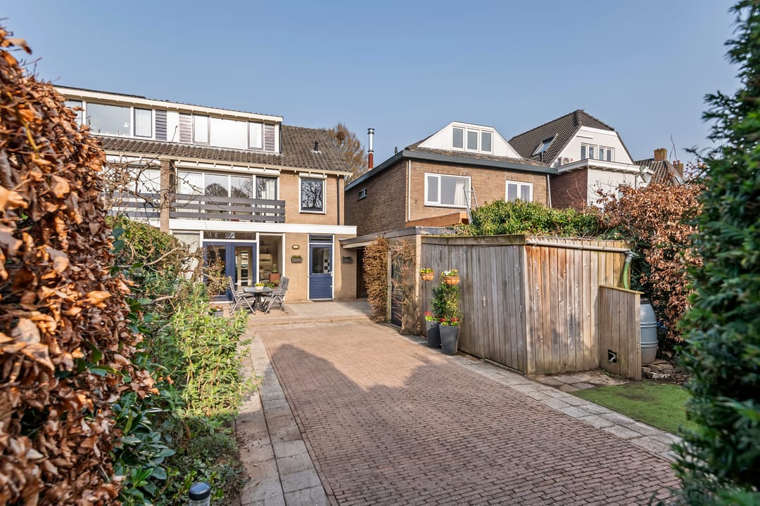 Spacious semi-detached home with character, featuring 5 bedrooms, suite-style living room, and sunny southwest garden — 49